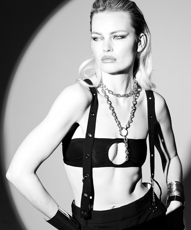 Model wearing Lunatic Femme Spotlight Ring Bandeau as a semi-sheer black top, styled with SNKX Straps as suspenders for a bold, power dressing lingerie look.