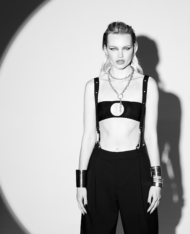 Model wearing black Lunatic Femme Spotlight Ring Bandeau as a sheer bandeau top, styled with SNKX straps as suspenders for a bold lingerie look with oversized ring detail at center.